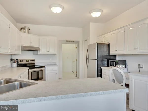 a kitchen with stainless steel appliances granite countertop a refrigerator sink and microwave