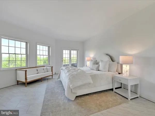 a spacious bedroom with a bed and a couch