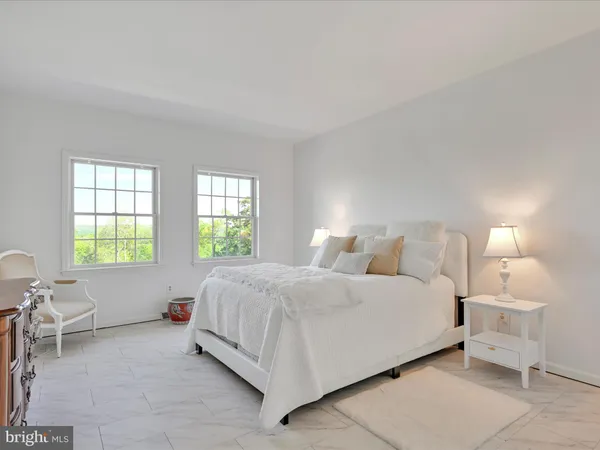 a bedroom with a bed a table and chair