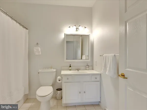 a bathroom with a sink toilet and mirror