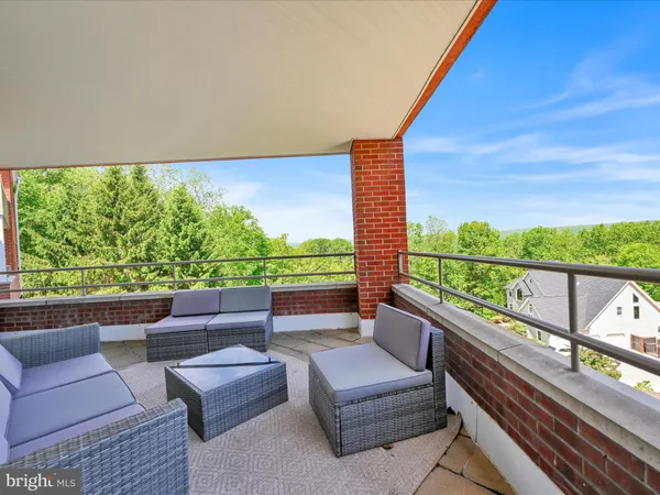 a view of balcony with couches and wooden floor