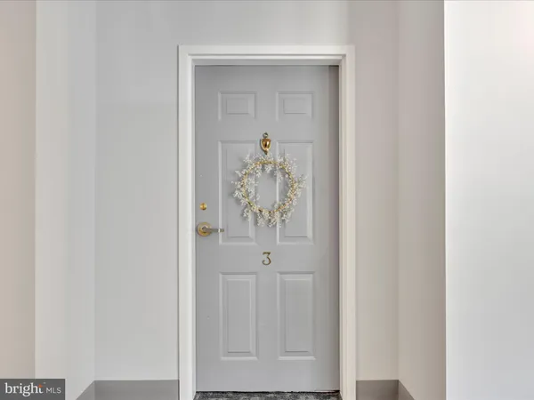 a view of a hallway with white doors