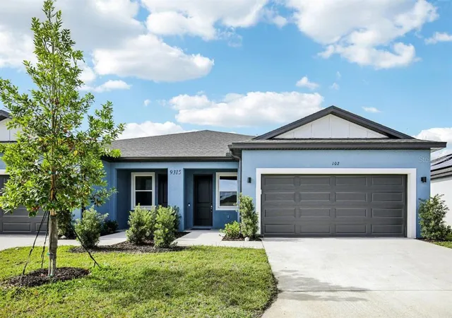 a front view of a house with a yard and garage