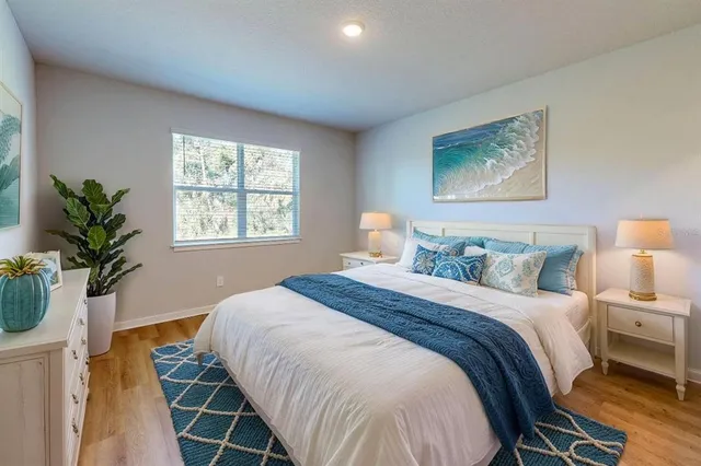 a bedroom with a bed and a potted plant