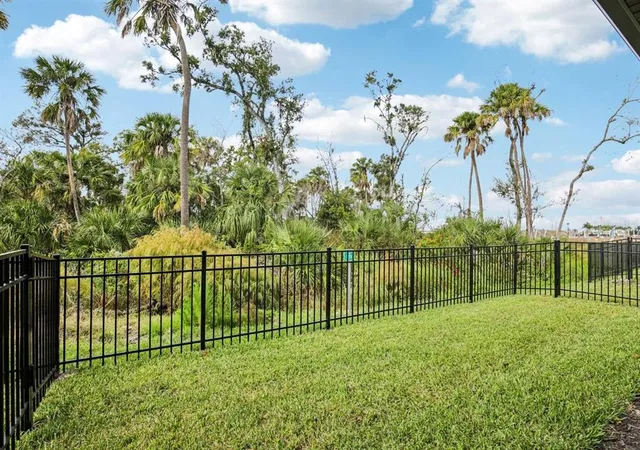 a view of a park with iron fence