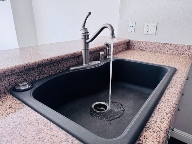a view of a patio with dining table and chairs