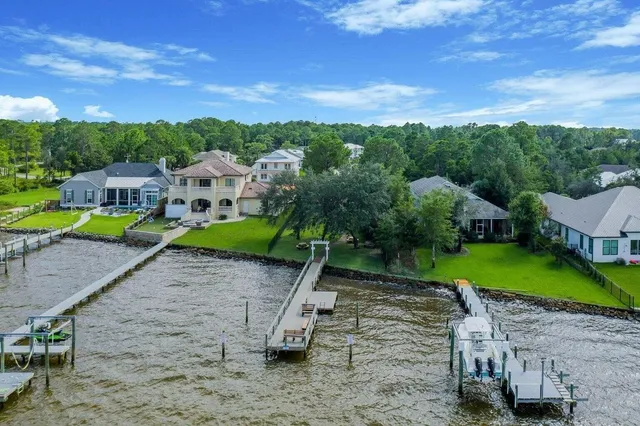 a swimming pool with outdoor seating and yard