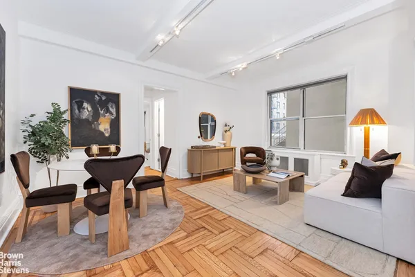 a living room with furniture fireplace and a table