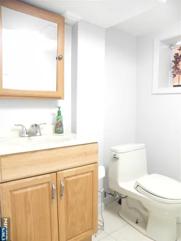 a bathroom with a toilet a sink and a mirror