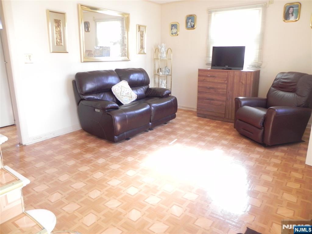 70 Christina Street Little Ferry, NJ 07643 - Photo 2 of 16 a living room with furniture and a flat screen tv