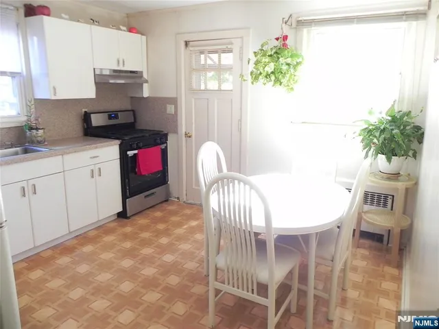 a kitchen with a table and chairs in it