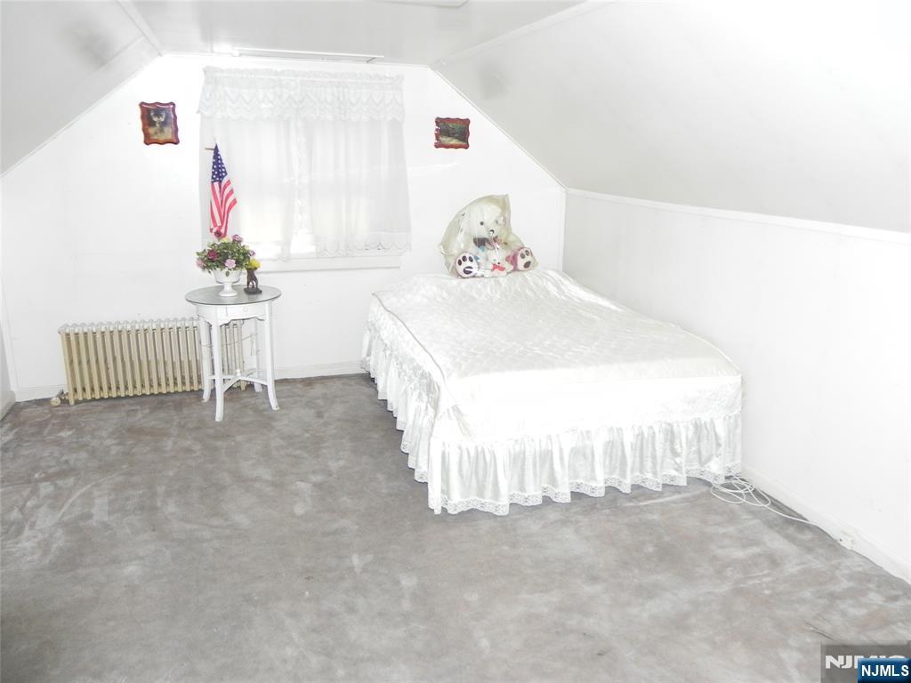 70 Christina Street Little Ferry, NJ 07643 - Photo 8 of 16 a bedroom with a bed and a chandelier