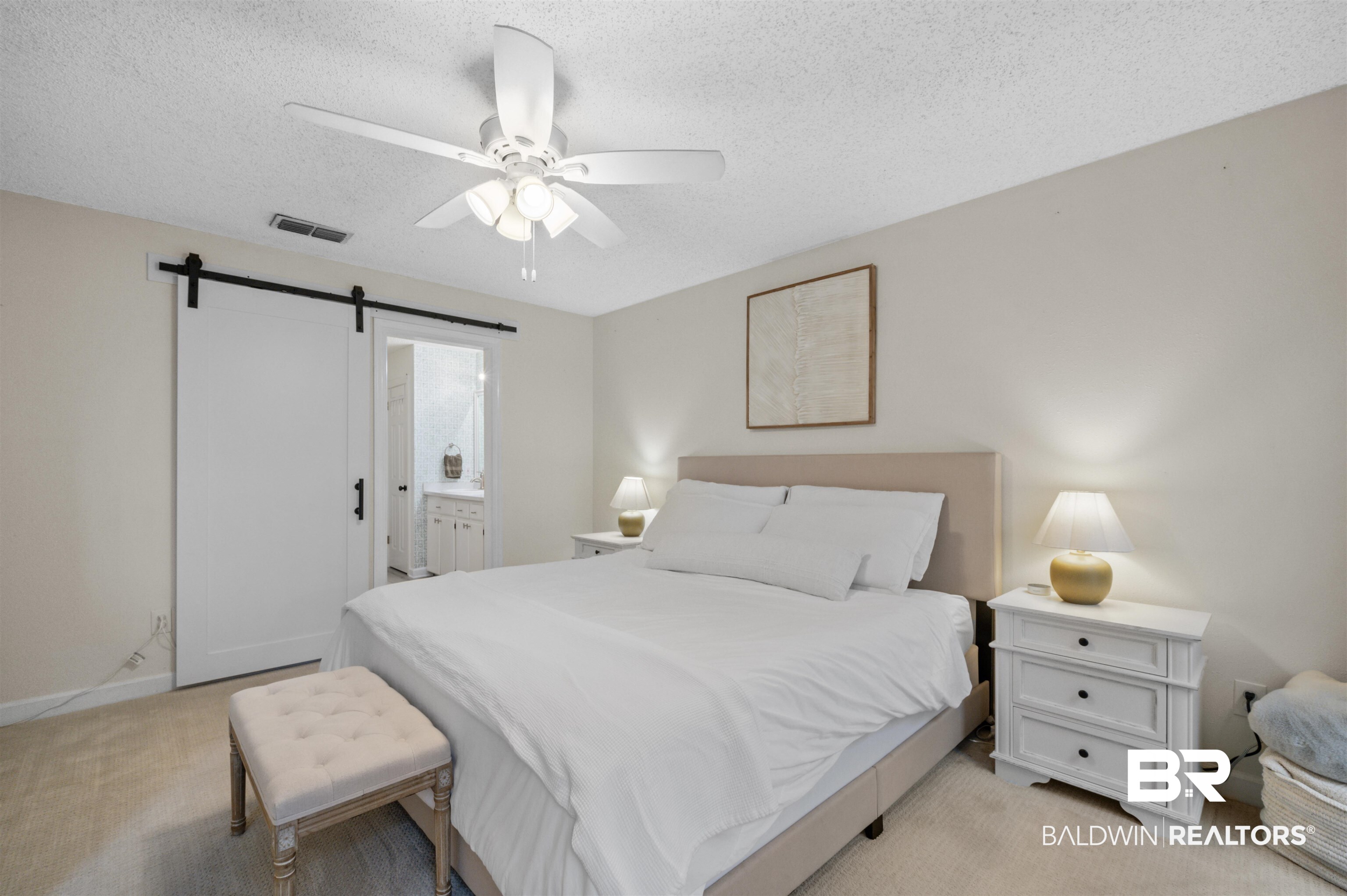 1066 Linlen Avenue Mobile, AL 36609 - Photo 11 of 22 Bedroom with a textured ceiling, a barn door, ceiling fan, visible vents, and light carpet