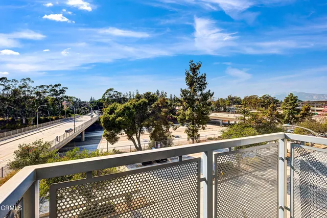a bedroom with a bed and a lamp on dresser