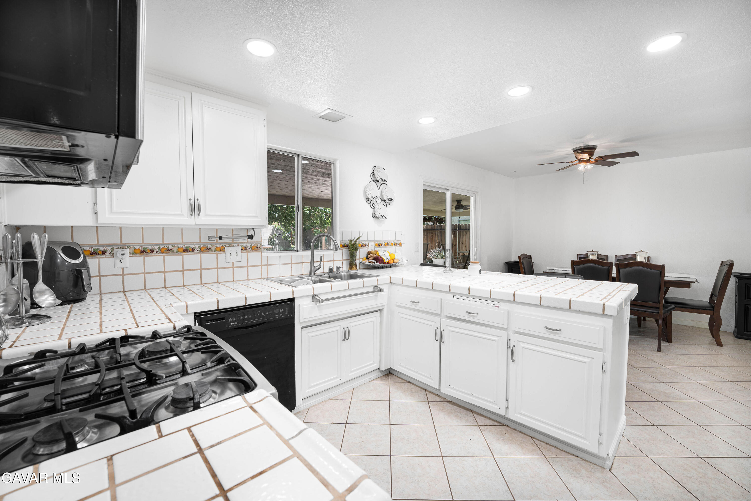 5009 East Ave R 11 Palmdale, CA 93552 - Photo 11 of 23 a kitchen with white cabinets and appliances