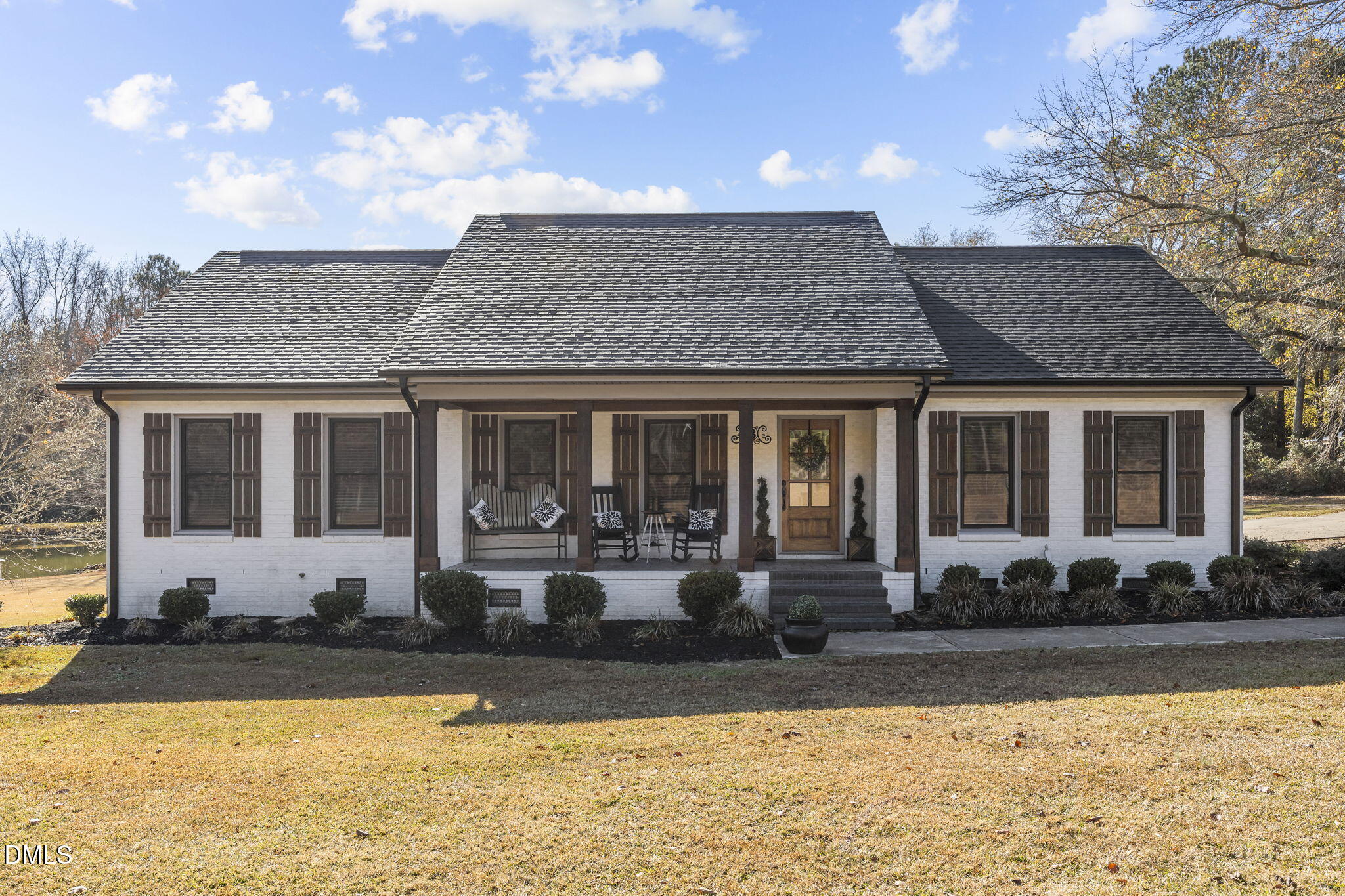 2079 Sheriff Johnson Road Lillington, NC 27546 - Photo 1 of 43 a front view of a house with swimming pool and porch