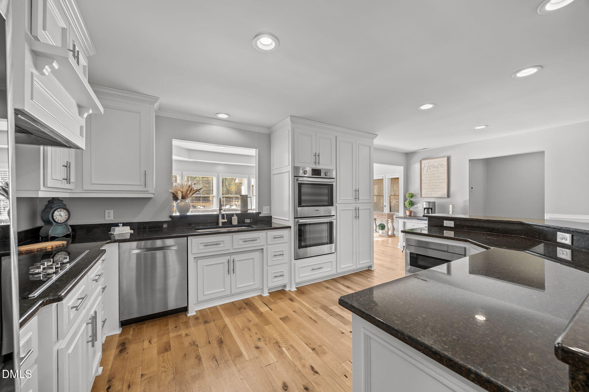 2079 Sheriff Johnson Road Lillington, NC 27546 - Photo 14 of 43 a kitchen with stainless steel appliances granite countertop a stove top oven a sink dishwasher a refrigerator and white cabinets with wooden floor
