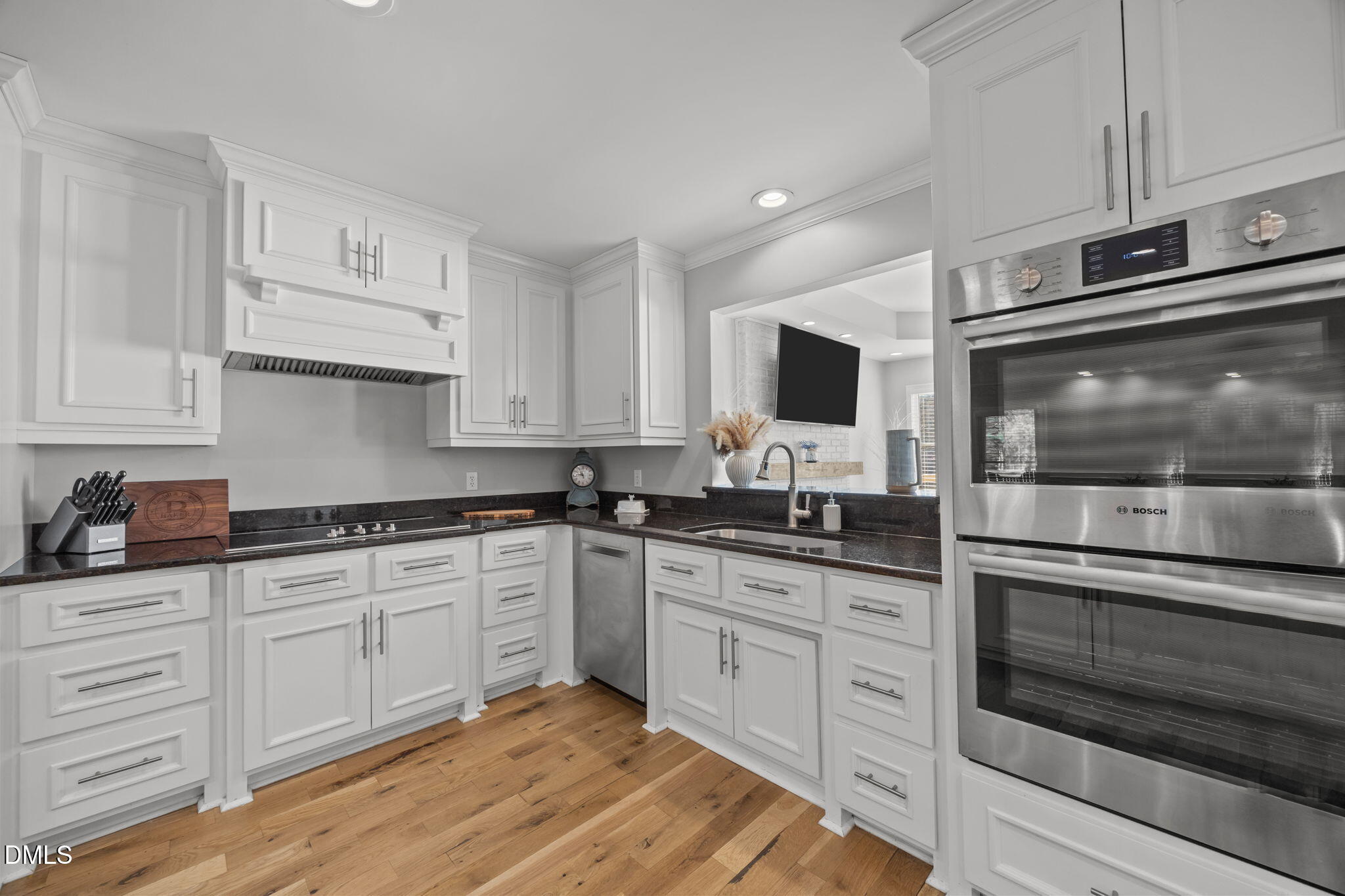 2079 Sheriff Johnson Road Lillington, NC 27546 - Photo 15 of 43 a kitchen with granite countertop white cabinets stainless steel appliances and a sink