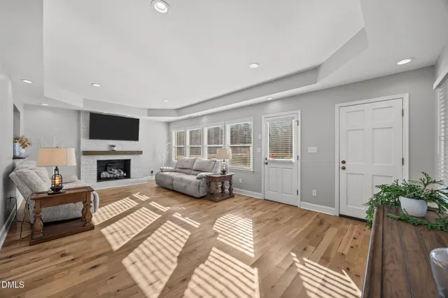 a living room with furniture fireplace and flat screen tv