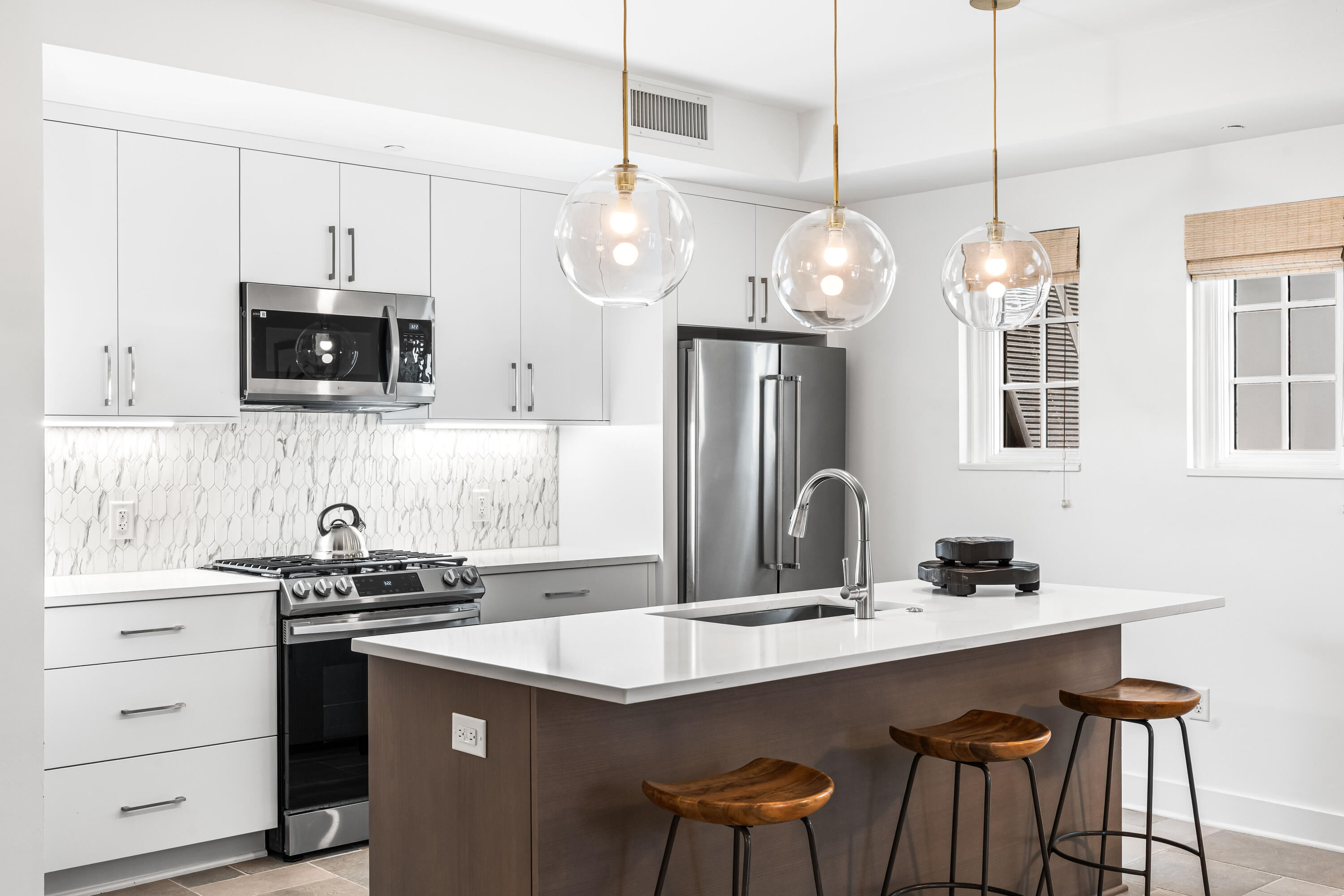 136 Georgetown Avenue, Unit 2D Inlet Beach, FL 32461 - Photo 39 of 48 a kitchen with a sink a counter space appliances and cabinets