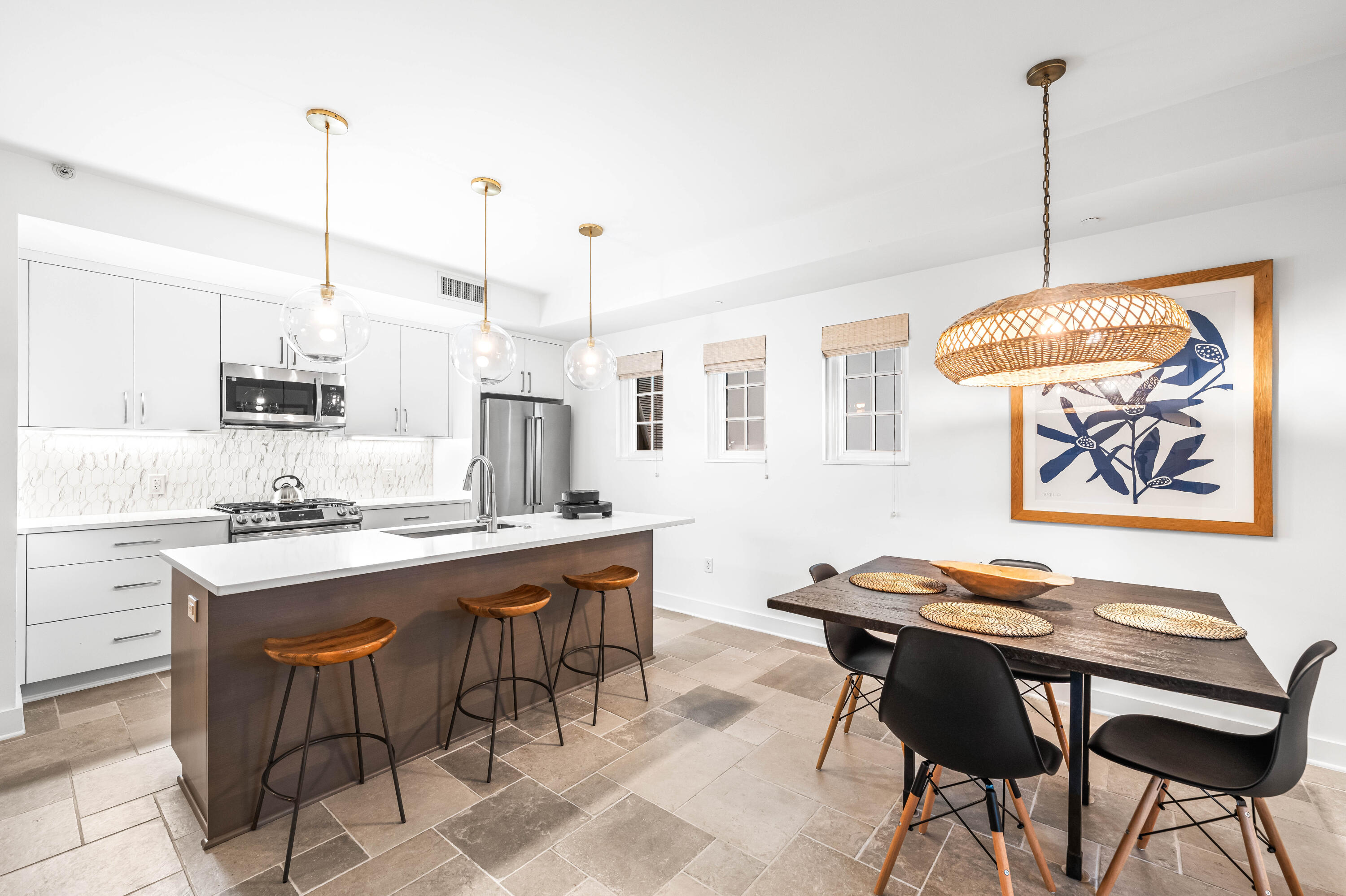 136 Georgetown Avenue, Unit 2D Inlet Beach, FL 32461 - Photo 6 of 48 a kitchen with stainless steel appliances kitchen island granite countertop a sink a stove a dining table and chairs