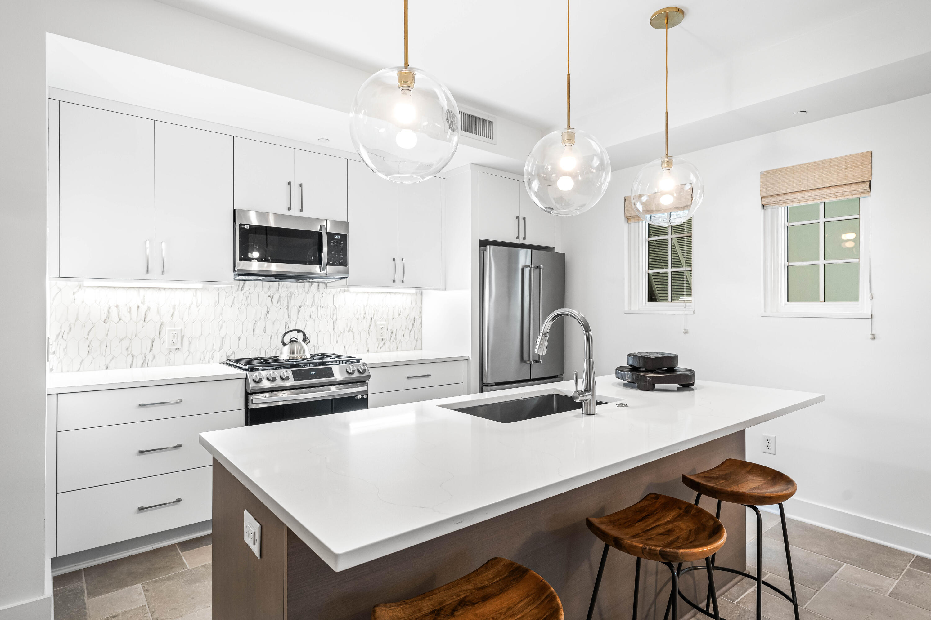136 Georgetown Avenue, Unit 2D Inlet Beach, FL 32461 - Photo 7 of 48 a kitchen with kitchen island a sink white cabinets and stainless steel appliances