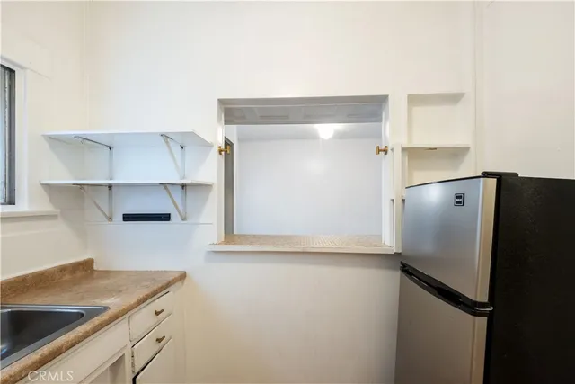 a kitchen with a refrigerator and a sink