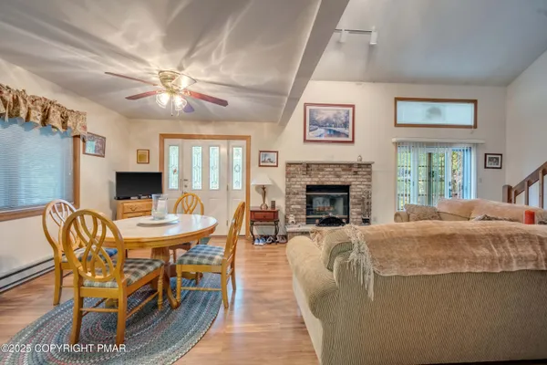 a living room with furniture a fireplace and a table