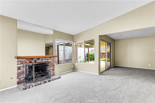 a view of a livingroom with an empty space and a fireplace