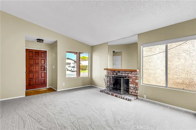 an empty room with furniture and a fireplace