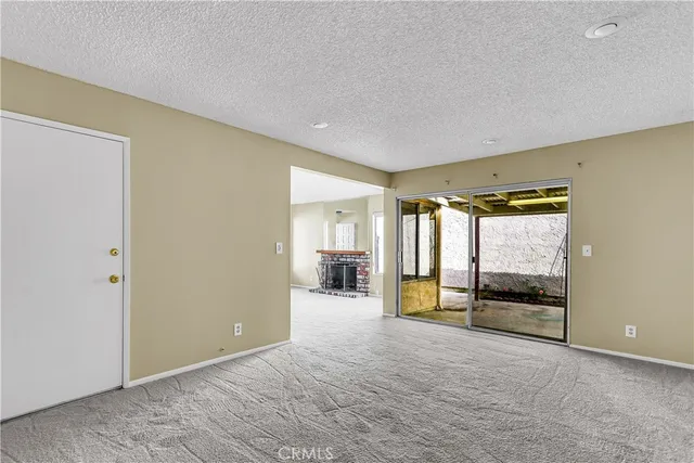 a view of an empty room with a fireplace