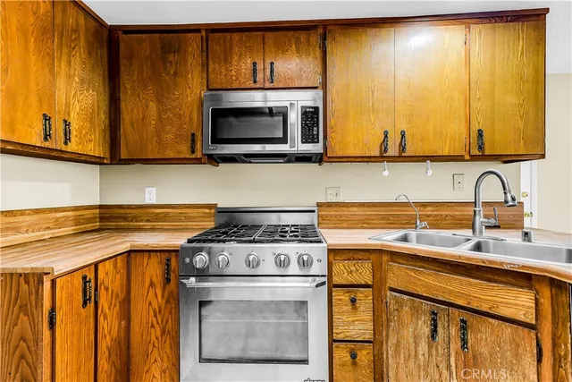 a kitchen with a stove a sink and a microwave