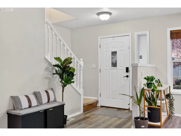 a kitchen with stainless steel appliances granite countertop a stove a sink a microwave a refrigerator and cabinets