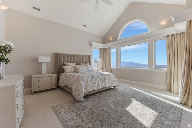3222 Eagle View Circle Sandy, UT 84092 - Photo 21 of 60 Bedroom with a mountain view, light colored carpet, multiple windows, a high ceiling, and a ceiling fan