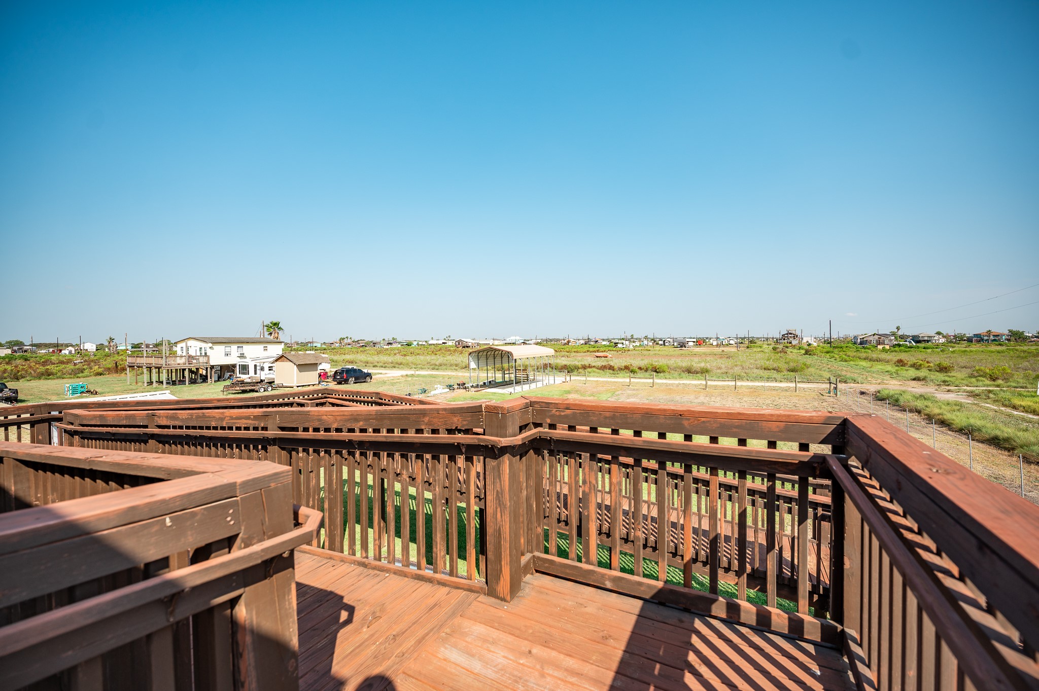 172 Curlew Street Sargent, TX 77414 - Photo 15 of 24 a view of a balcony with wooden floor and ocean view