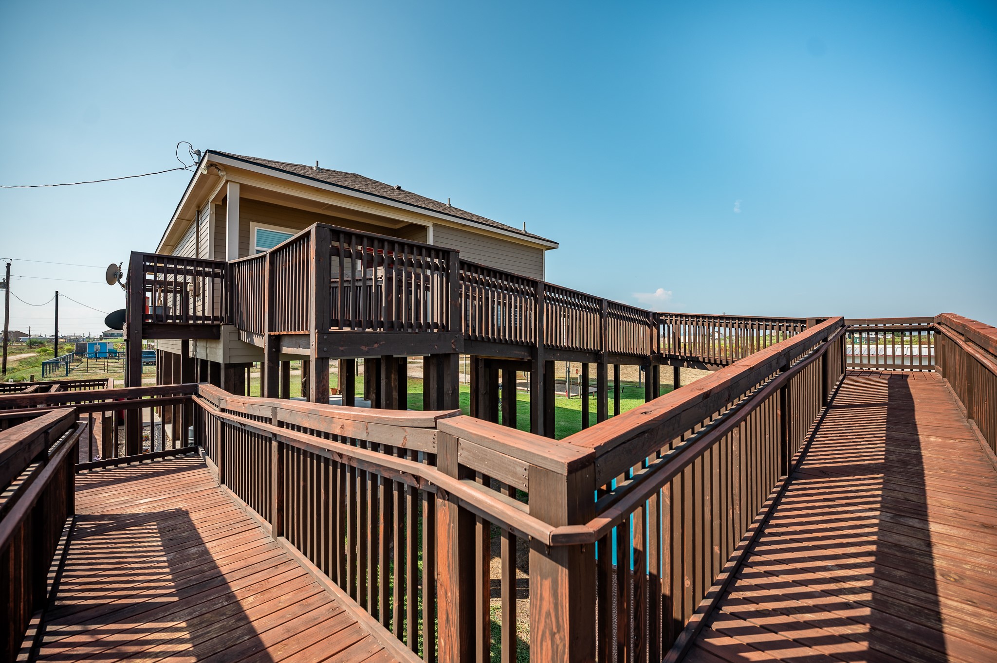 172 Curlew Street Sargent, TX 77414 - Photo 16 of 24 a view of a house with wooden deck