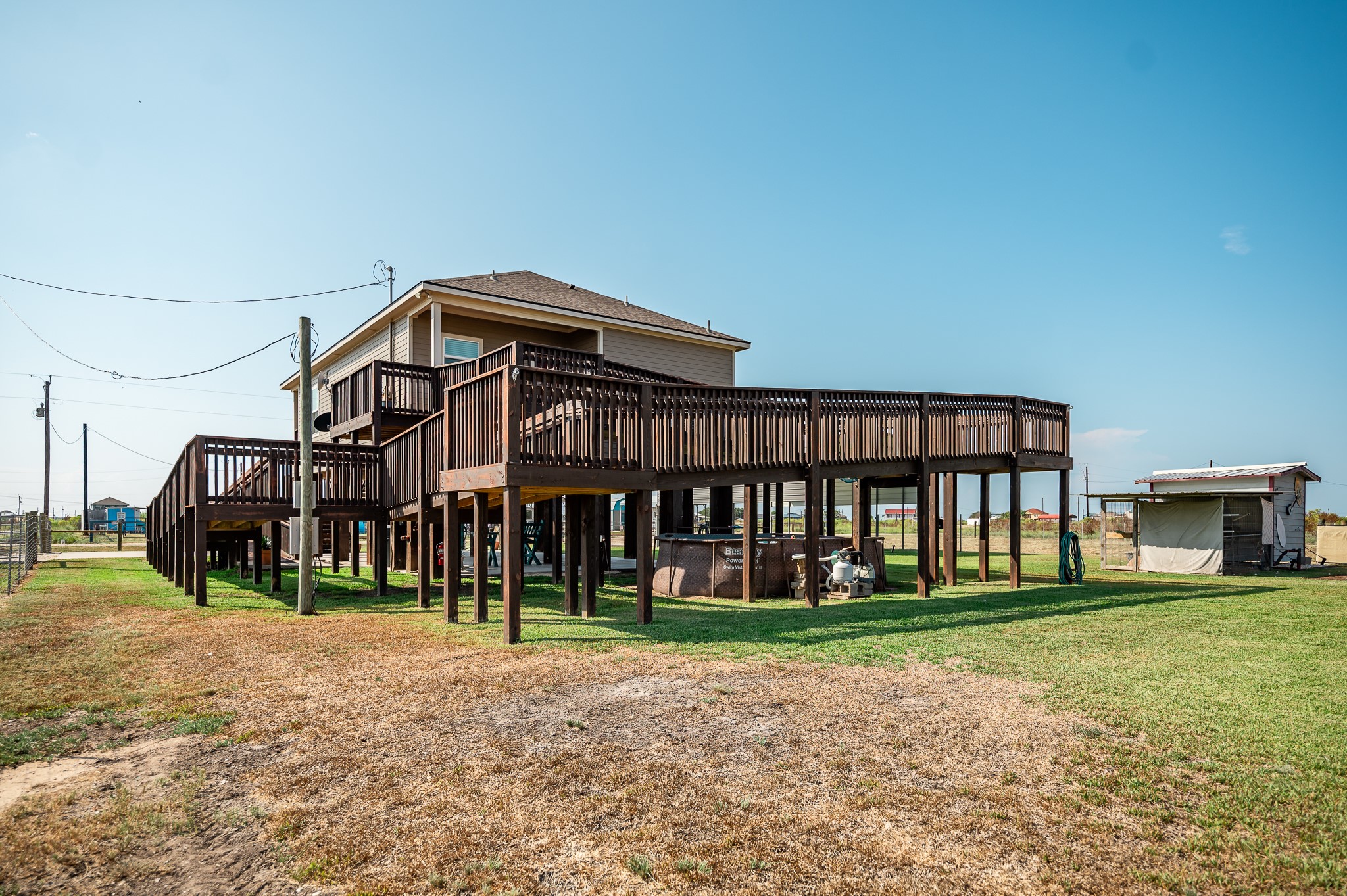 172 Curlew Street Sargent, TX 77414 - Photo 19 of 24 a front view of a house with garden