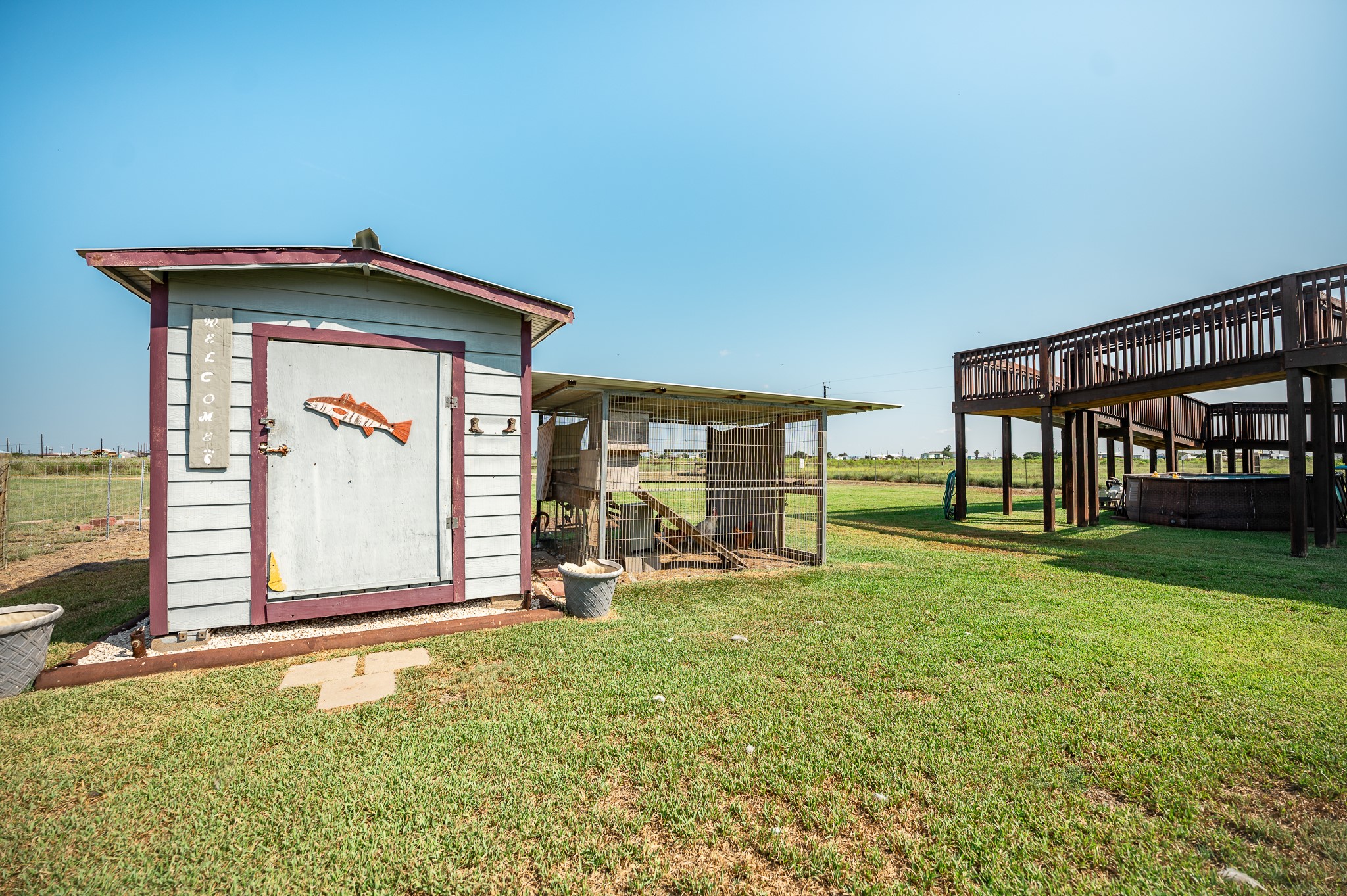 172 Curlew Street Sargent, TX 77414 - Photo 22 of 24 a view of a front of a house with a yard