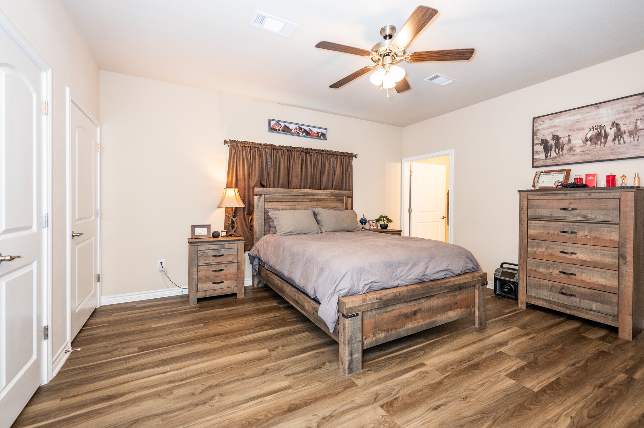 172 Curlew Street Sargent, TX 77414 - Photo 9 of 24 a bed room with a bed and a ceiling fan