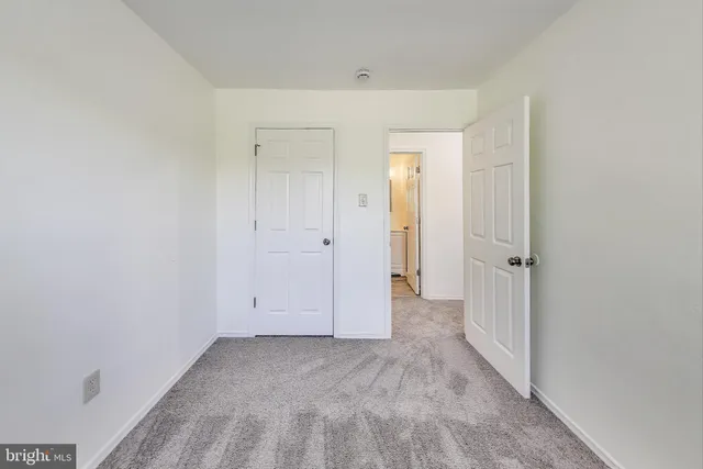 a white toilet sitting next to a bathroom sink and vanity
