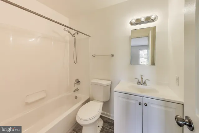 a front view of a house with garden and yard