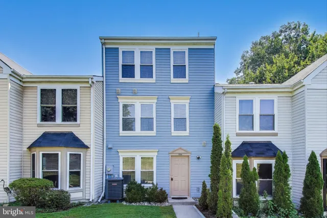 a front view of a house with garden and yard