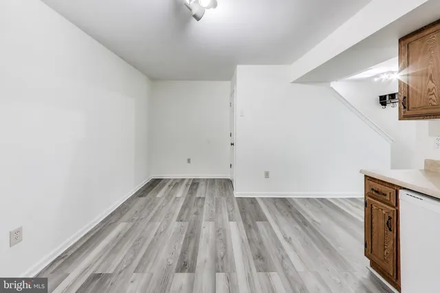 a view of storage and utility room with wooden floor
