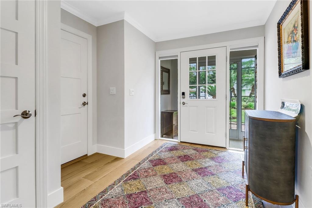 14 Rivard Road, Unit 7 Naples, FL 34112 - Photo 2 of 26 Solid wood doors and quality wood-look tile flooring throughout home