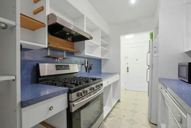 a kitchen with stainless steel appliances granite countertop a stove and a sink