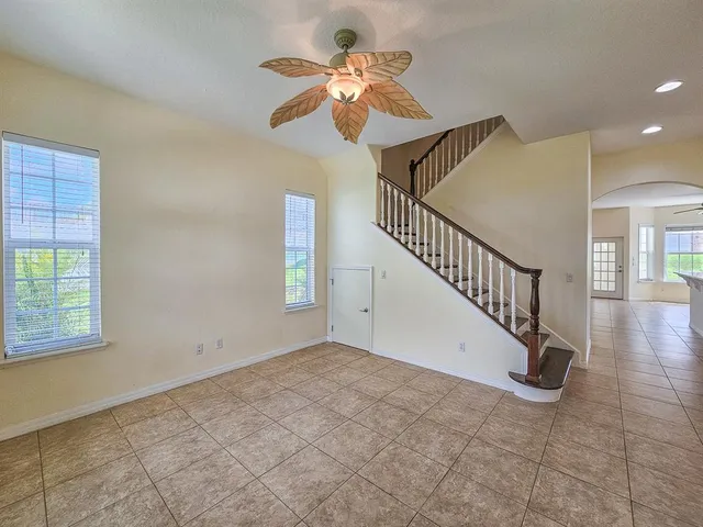 a large white kitchen with a large window