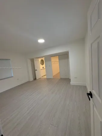 a view of a room with wooden floor and cabinet