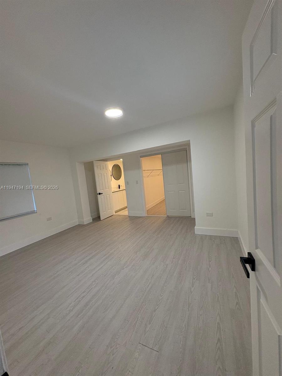 6104 Southwest 33rd Street Miramar, FL 33023 - Photo 13 of 31 a view of a room with wooden floor and cabinet