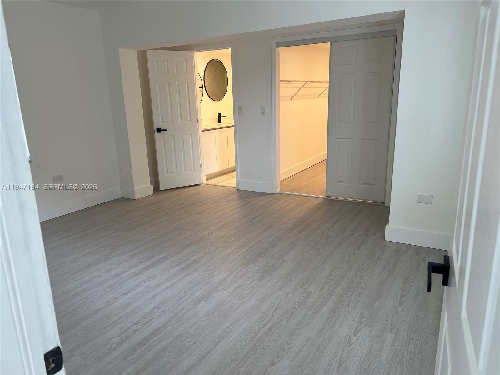6104 Southwest 33rd Street Miramar, FL 33023 - Photo 14 of 31 an empty room with wooden floor and windows