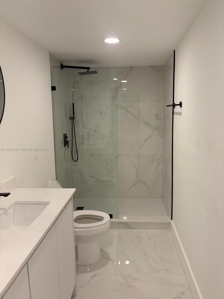 6104 Southwest 33rd Street Miramar, FL 33023 - Photo 16 of 31 a bathroom with a sink a toilet and shower